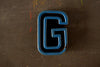 Vintage Industrial Letter "G" Black with Blue and Orange Paint, 2" tall (c.1940s) - thirdshift