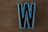 Vintage Industrial Letter "W" Black with Blue and Orange Paint, 2" tall (c.1940s) - thirdshift