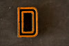 Vintage Industrial Letter "D" Black with Light Orange and Blue Paint, 2" tall (c.1940s) - thirdshift