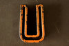 Vintage Industrial Letter "U" Black with Light Orange and Blue Paint, 2" tall (c.1940s) - thirdshift