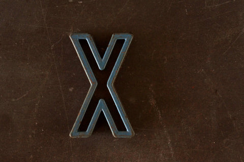 Vintage Industrial Letter "X" Black with Orange and Blue Paint, 2" tall (c.1940s) - thirdshift