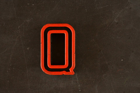 Vintage Industrial Letter "Q" Black with Orange and Green Paint, 2" tall (c.1940s) - thirdshift