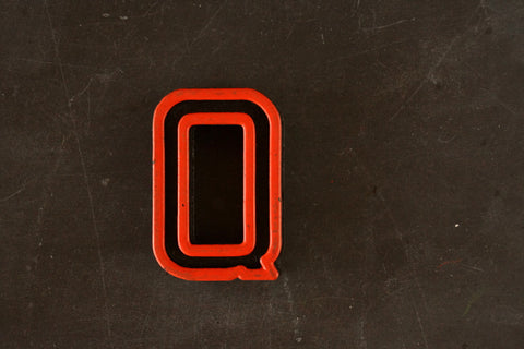 Vintage Industrial Letter "Q" Black with Orange and Green Paint, 2" tall (c.1940s) - thirdshift