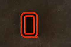Vintage Industrial Letter "Q" Black with Orange and Green Paint, 2" tall (c.1940s) - thirdshift