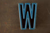 Vintage Industrial Letter "W" Black with Blue and Orange Paint, 2" tall (c.1940s) - thirdshift