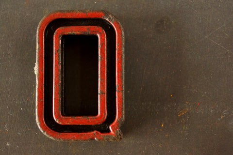 Vintage Industrial Letter "Q" Black with Red and Green Paint, 2" tall (c.1940s) - thirdshift