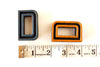 Vintage Industrial Letter "D" Black with Light Orange and Blue Paint, 2" tall (c.1940s) - thirdshift