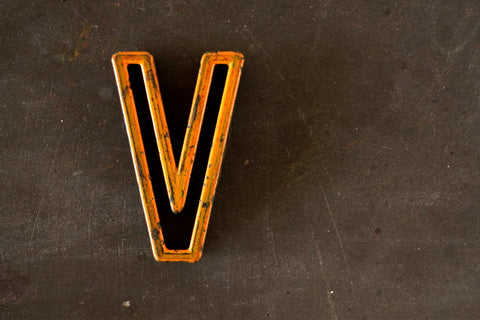 Vintage Industrial Letter "V" Black with Light Orange and Blue Paint, 2" tall (c.1940s) - thirdshift