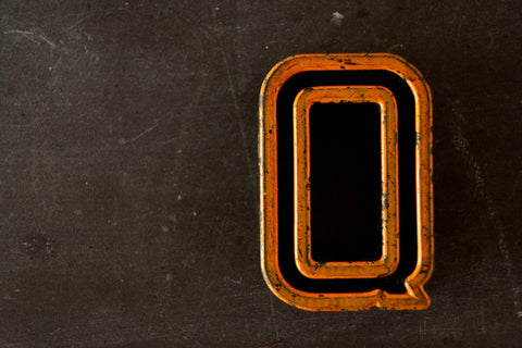 Vintage Industrial Letter "Q" Black with Light Orange and Green Paint, 2" tall (c.1940s) - thirdshift