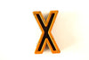 Vintage Industrial Letter "X" Black with Light Orange and Blue Paint, 2" tall (c.1940s) - thirdshift
