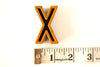 Vintage Industrial Letter "X" Black with Light Orange and Blue Paint, 2" tall (c.1940s) - thirdshift