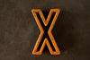 Vintage Industrial Letter "X" Black with Light Orange and Blue Paint, 2" tall (c.1940s) - thirdshift