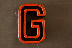 Vintage Industrial Letter "G" Black with Orange and Blue Paint, 2" tall (c.1940s) - thirdshift