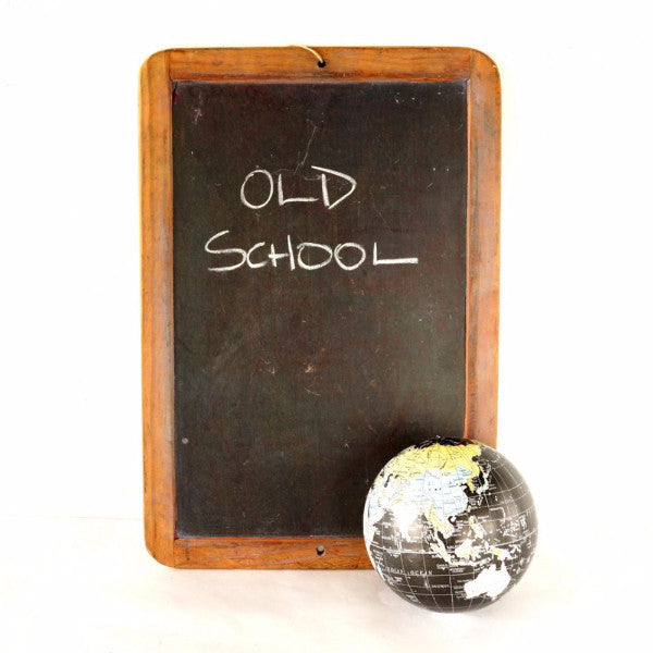 School Written on Vintage Chalkboard and a Chalk on the Board